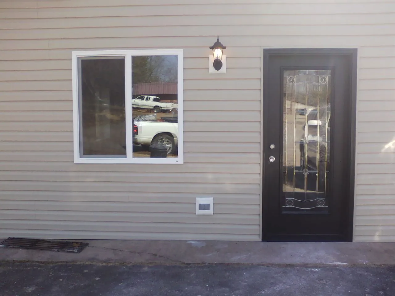 New siding, window and entry door on the side of an addition in Waterloo